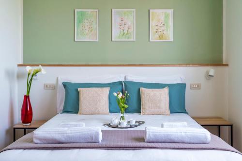 a bedroom with a bed with a vase of flowers on it at Agriturismo San Francesco in Cortona