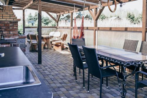 an outdoor patio with a table and chairs at VERTIKĀLES in Liepāja