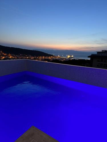 a swimming pool on the roof of a building at night at Nova Butik Hotel Çeşme in Cesme