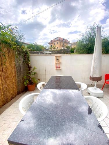 a black table and chairs on a patio at Villa Elisa in Minturno