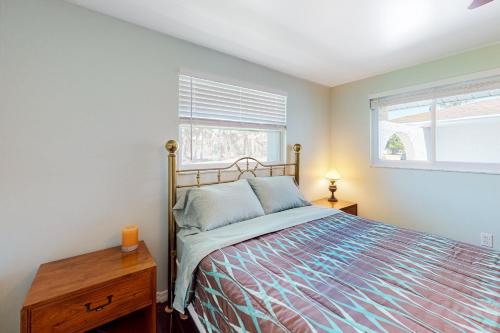 a bedroom with a bed and a window at Dune Our Thing in Rotonda West