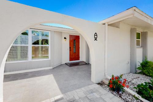a white house with a red door at Dune Our Thing in Rotonda West