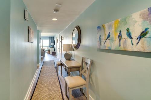 a hallway with chairs and paintings on the wall at Pool Access and Views at Saint Helena Island Condo! in Oceanmarsh Subdivision