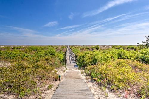 a wooden boardwalk in the middle of a field at Pool Access and Views at Saint Helena Island Condo! in Oceanmarsh Subdivision