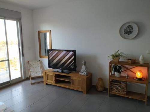 a living room with a flat screen tv on a table at Lovely 1bed apartment with padel court near beach in Moncófar