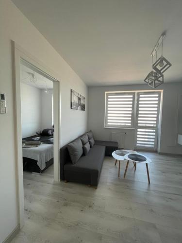 a living room with a couch and a table and a bed at N° 60 in Płock