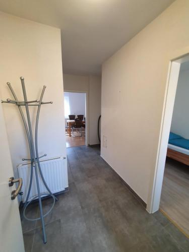 an empty room with a door and a room with a bed at DAEL in Leoben