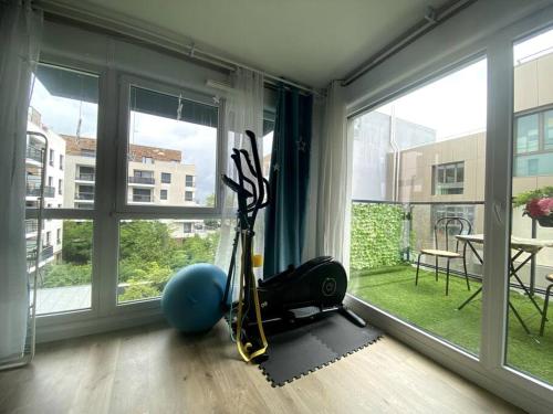 a room with a gym with a large window at Construit en 2020, 82m2, entre paris et disney in Noisy-le-Grand