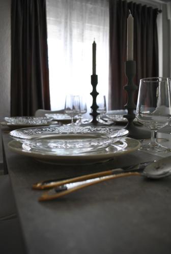 a table with plates and glasses on top of it at Viviendas De Uso Turistico Rocinante TOLEDO in Toledo