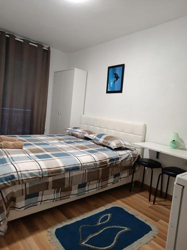 a bedroom with a bed and a table at Silent home in Visoko