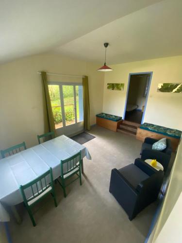 a living room with a blue table and chairs at Manot Vacances - Gites en bord de Vienne in Manot