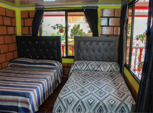 two beds in the back of a bus at Finca Villa Hermosa in Alcalá