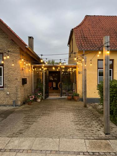 a building with a courtyard with lights on it at Room 16 - Hawkraft kulturhotel in Vestervig