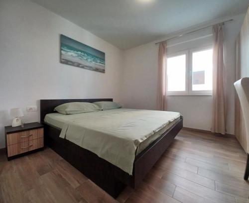 a bedroom with a large bed and a window at Sol in Kremena