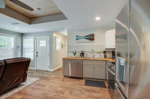 a kitchen with a sink and a refrigerator at Lake Conroe Vacation Rental half Mi to Boat Launch! in Willis