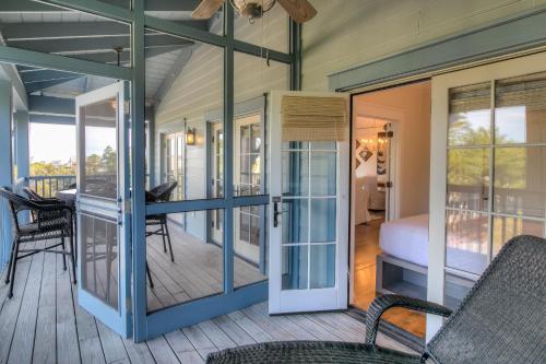 a room with a balcony with a bed and a table at Lighthouse Loft in Santa Rosa Beach