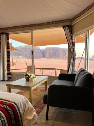 a living room with a couch and a table at Wadi Rum Bedouin Camp in Wadi Rum