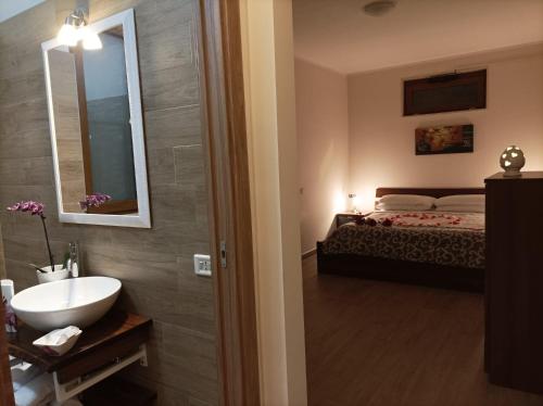 a bathroom with a sink and a bed in a room at Sognando Alberobello in Alberobello