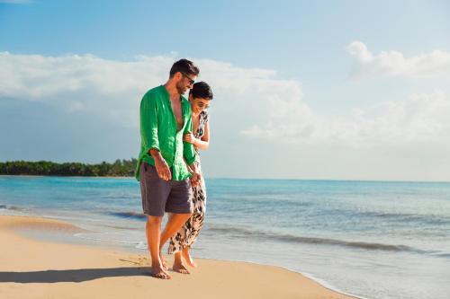 a man and a woman walking on the beach at Paradisus La Perla - Adults Only All Inclusive in Playa del Carmen