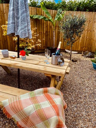 a picnic table in a garden with a blanket on it at Highgate Mountain in Pembrokeshire