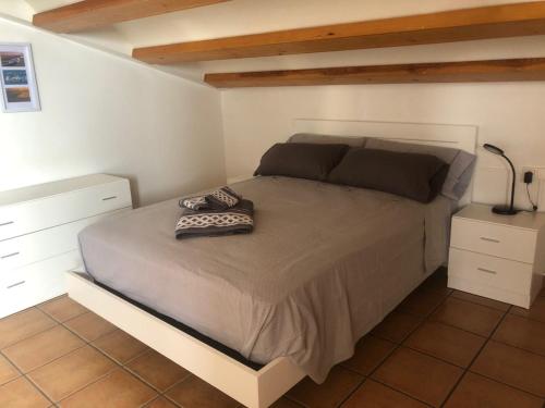 a bedroom with a large bed with two night stands at Mirariu in Els Muntells