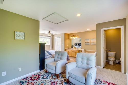a living room with two chairs and a bathroom at Cozy Resort-Style Escape on Taylorsville Lake! in Taylorsville