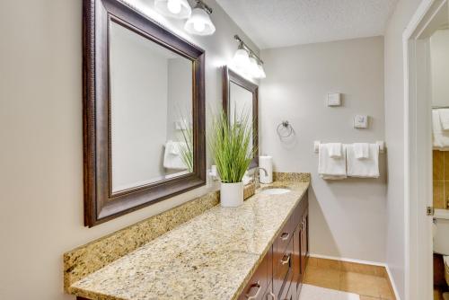 a bathroom with a sink and a mirror at Florida Getaway - Balconies, Grill and Near Beaches! in Daytona Beach