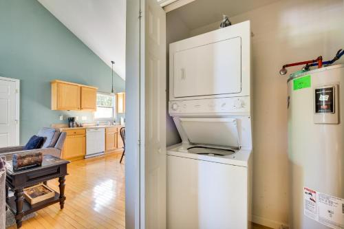 a kitchen with a washer and dryer next to a refrigerator at Taylorsville Lake Cottage Rental with Hot Tub! in Taylorsville