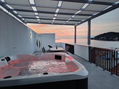 a hot tub on the balcony of a house at D-Sunrise in Kali