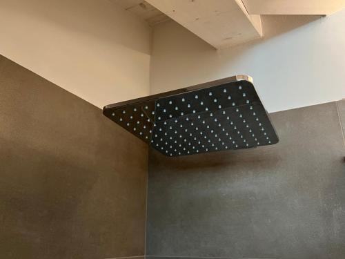 a polka dot light on the corner of a room at Camelot Luxury Houses Horses in Pellizzano
