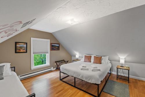 a bedroom with two beds in a attic at Cozy house close to Brandeis, Bentley, Moody St in Waltham