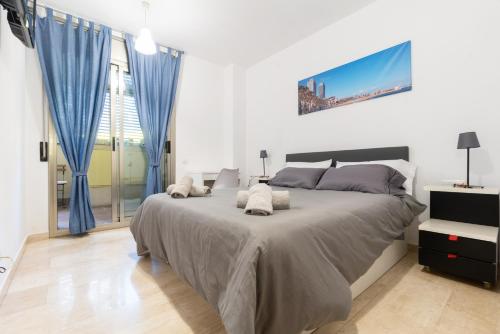 a bedroom with a large bed with blue curtains at Apartament Granollers Up Live I in Granollers