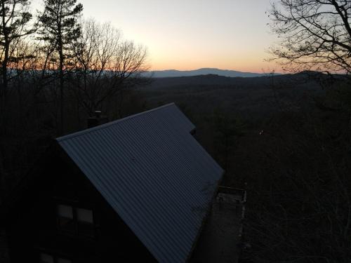 a roof of a house with the sunset in the background at Amazing Views~Secluded Retreat~HotTub~GameRoom in Mineral Bluff