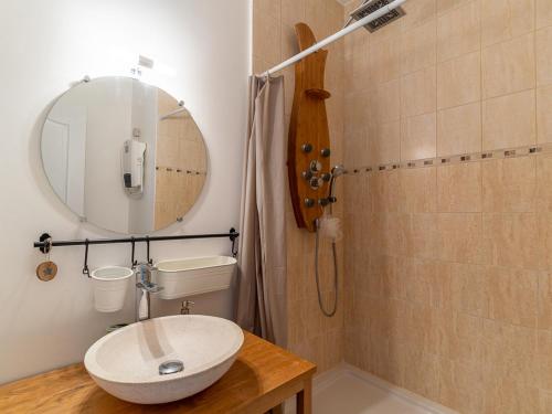 a bathroom with a sink and a mirror and a shower at Maison à Mimizan avec piscine, 4 personnes, proche lac, activités à proximité - FR-1-50-102 in Mimizan
