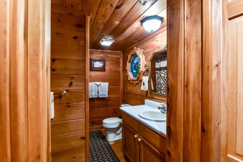 a wooden bathroom with a sink and a toilet at Amazing Views~Secluded Retreat~HotTub~GameRoom in Mineral Bluff