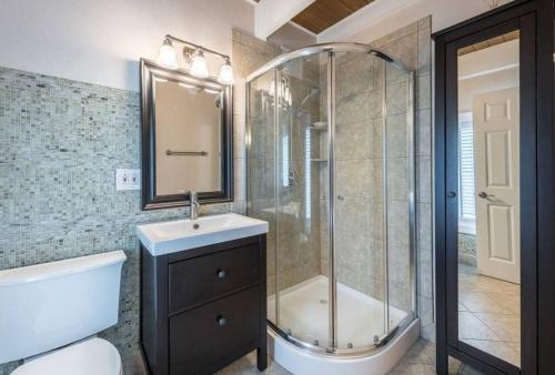 uma casa de banho com um chuveiro, um lavatório e um WC. em Glen Ellyn Countryside Home em Glen Ellyn