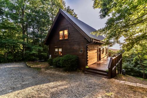 a log cabin with a wooden deck and a porch at Amazing Views~Secluded Retreat~HotTub~GameRoom in Mineral Bluff