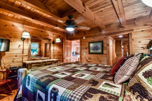 a bedroom with a bed in a log cabin at Amazing Views~Secluded Retreat~HotTub~GameRoom in Mineral Bluff