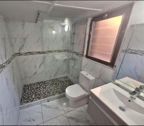 a white bathroom with a toilet and a sink at San Lameer Villa 2026 in Southbroom