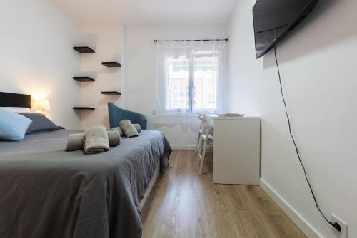 a bedroom with a bed and a desk and a window at Apartment Granollers Up Live II in Granollers