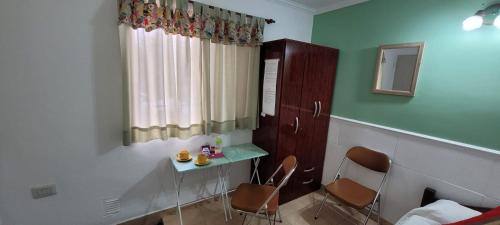 a room with two chairs and a table and a window at Chayerita - Suite en La Rioja in La Rioja