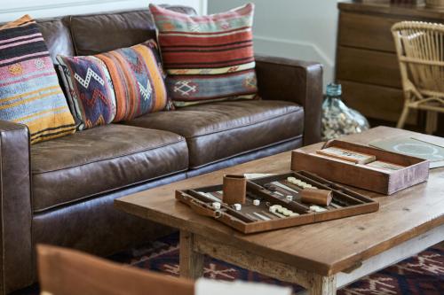 a living room with a leather couch and a coffee table at Hotel Carmel in Carmel