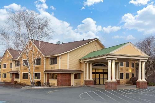 a large yellow building with a green roof at Best Western The Inn at Sharon - Foxboro in Sharon