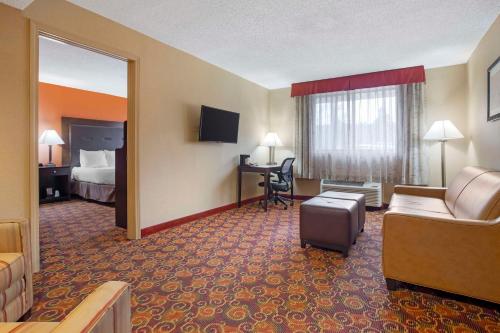 a hotel room with a couch and a bed and a desk at Best Western The Inn at Sharon - Foxboro in Sharon