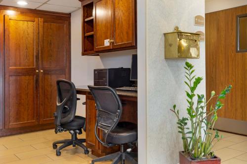 a kitchen with two chairs sitting at a desk at Best Western The Inn at Sharon - Foxboro in Sharon