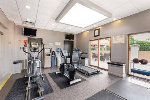 a gym with treadmills and machines in a room at Best Western Plus The Charles Hotel in St. Charles