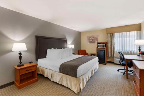 a hotel room with a bed and a desk at Best Western Plus The Charles Hotel in St. Charles