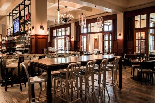 a restaurant with a large table and chairs at Royal Park Hotel in Rochester