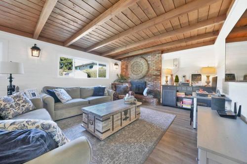 a living room with a couch and a table at Private Heated Pool Oasis/Disney/Retro Arcade/Gym in Placentia