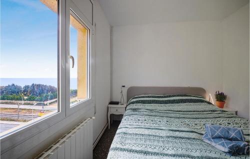 a white bedroom with a bed and a window at 3 Bedroom Awesome Apartment In Pineda De Mar in Pineda de Mar